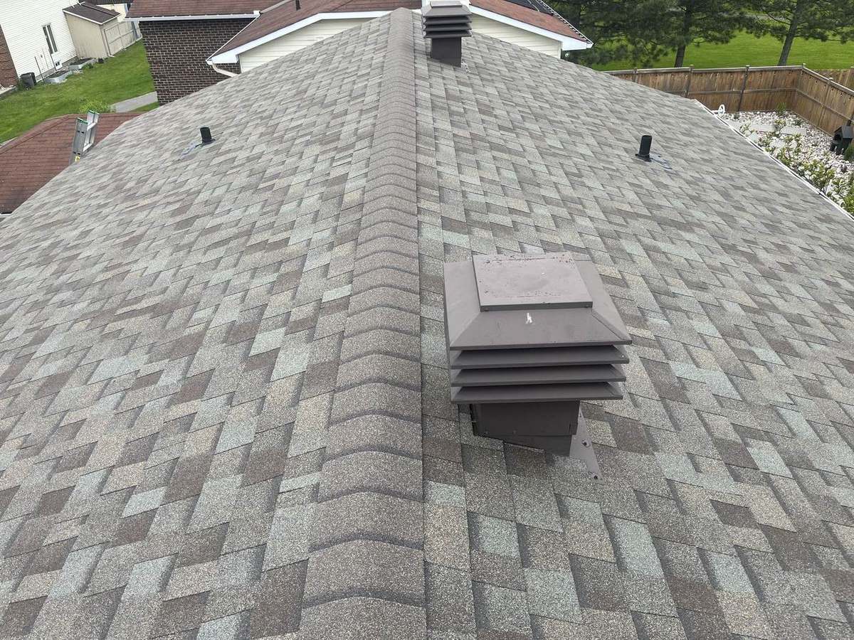 Driftwood shingle roof replacement with crisp ridge cap and clean detail work