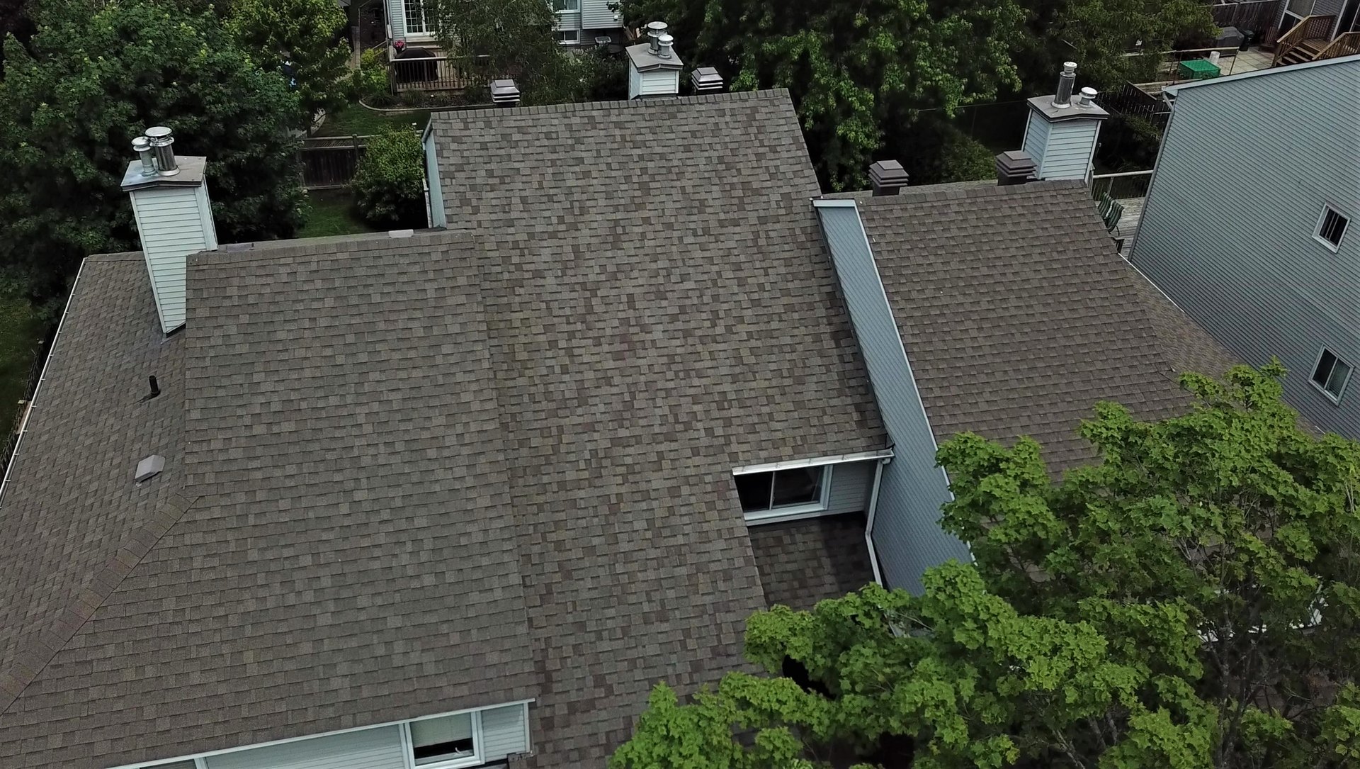 Shingle roof detail showing new ridge cap and flashing