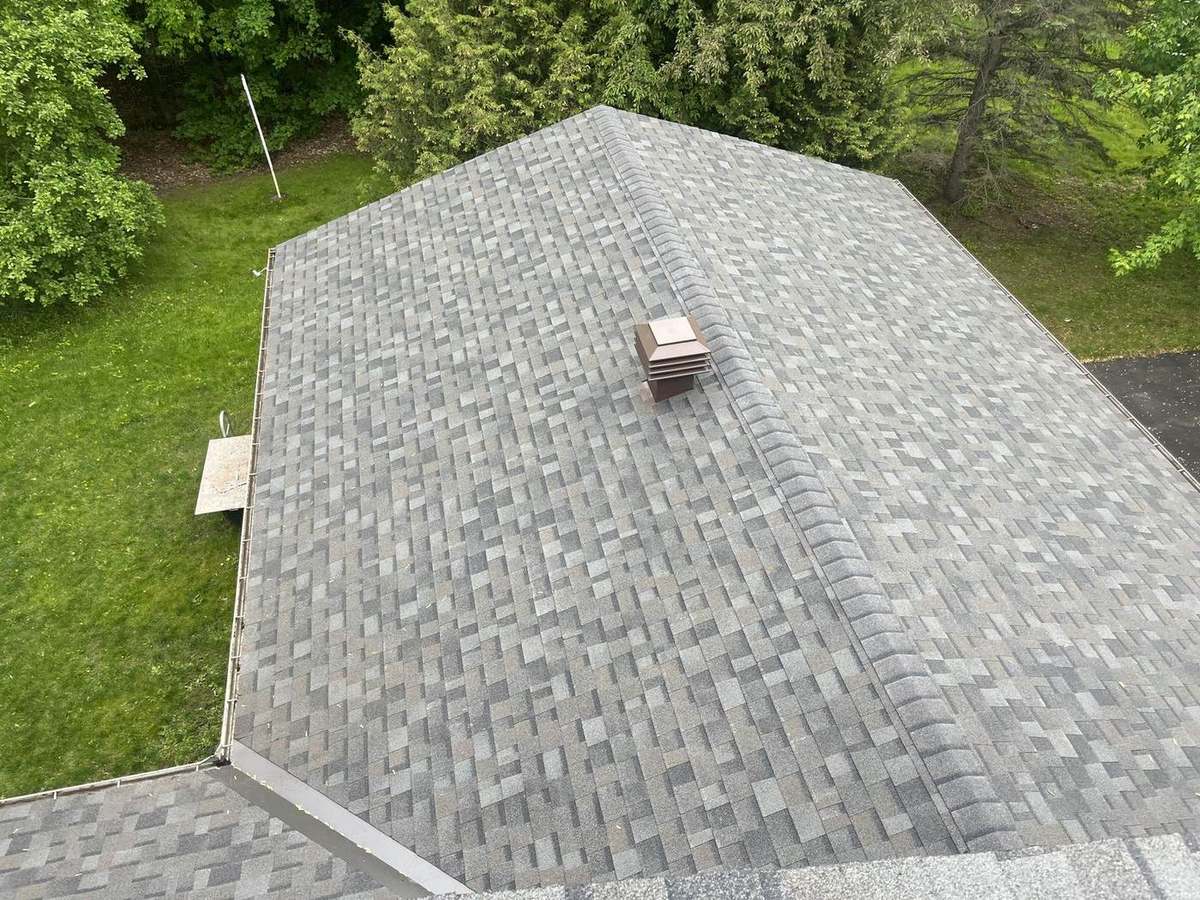 Close view of a well-maintained shingle roof edge and ridge
